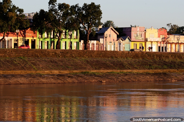 Historical houses in pastel colors glow in the Acre River in the golden hour in Rio Branco. (720x480px). Brazil, South America.