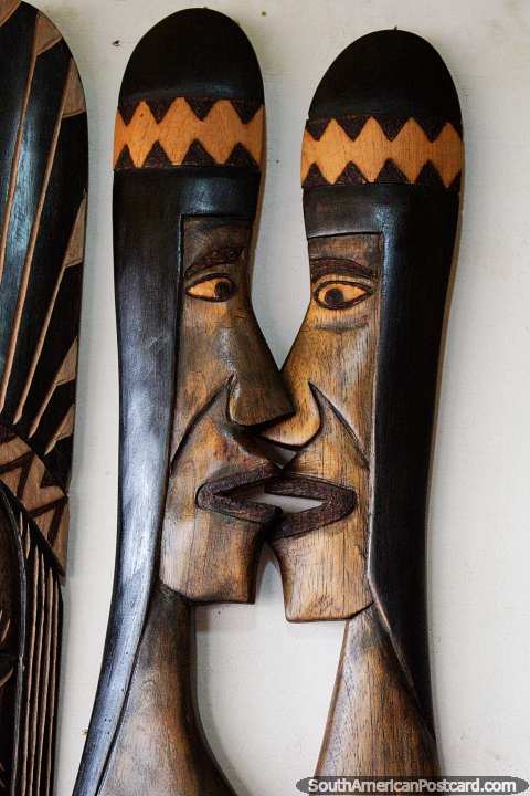 Wooden crafts of indigenous faces at the crafts fair in Porto Velho, face to face. (480x720px). Brazil, South America.