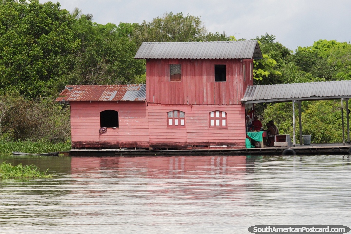 2 storey pink house built on a platform on the Amazon river in Manaus. (720x480px). Brazil, South America.