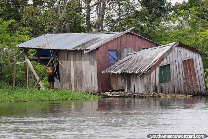 One wooden house replaced by another as it sinks into the water in the Amazon in Manaus. (720x480px). Brazil, South America.