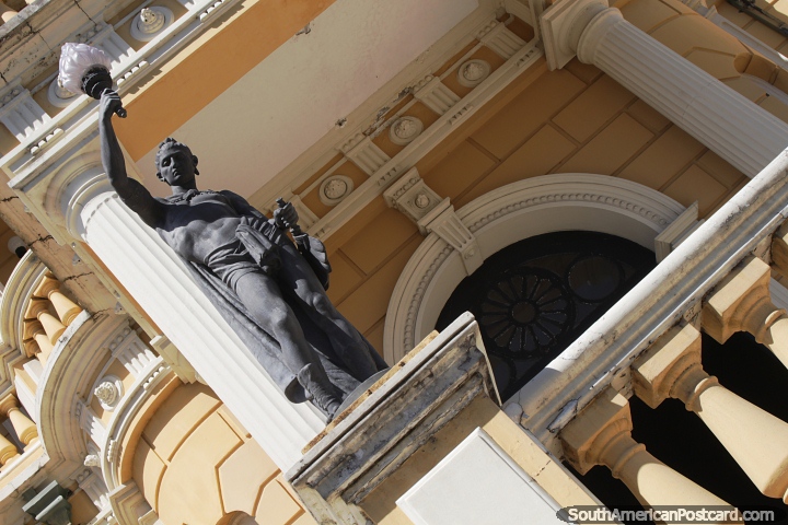 Statue holding a light at the main entrance of Rio Negro Palace in Manaus. (720x480px). Brazil, South America.