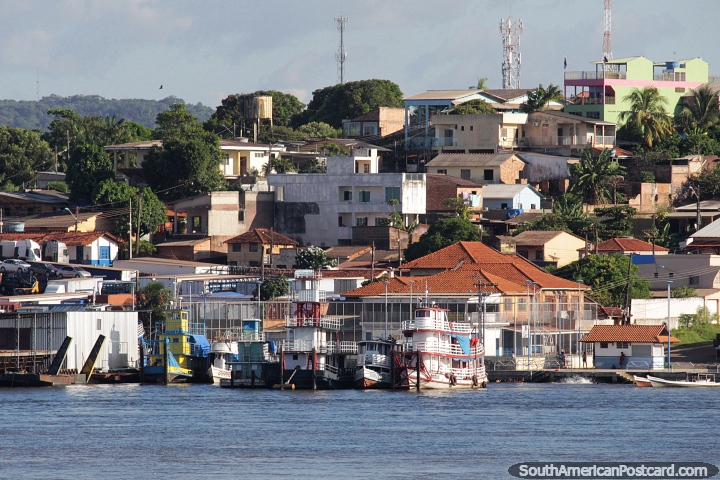 Ferries moored on the riverfront in Santarem, a hill with houses. (720x480px). Brazil, South America.