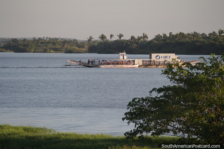 Barge carries a truck and cars on the Tocantins River, passing by Carolina. (720x480px). Brazil, South America.