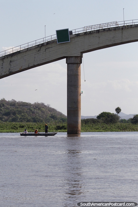 Boat under the bridge in the port area in Corumba. (480x720px). Brazil, South America.