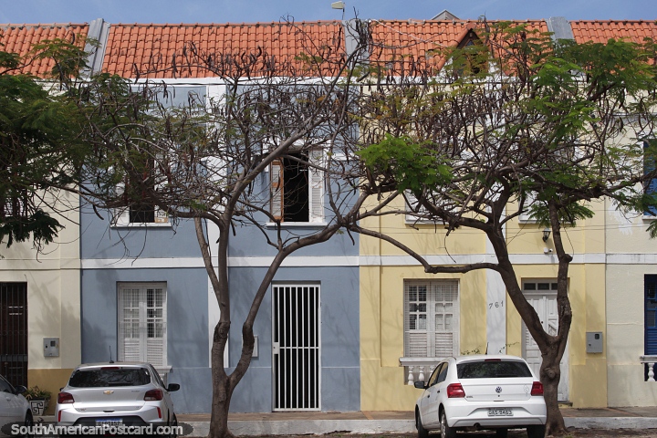 Row of red-tiled roofed houses painted in light colors in Corumba. (720x480px). Brazil, South America.