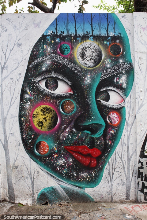 Colorful face with planets at Beco do Batman in Sao Paulo. (480x720px). Brazil, South America.