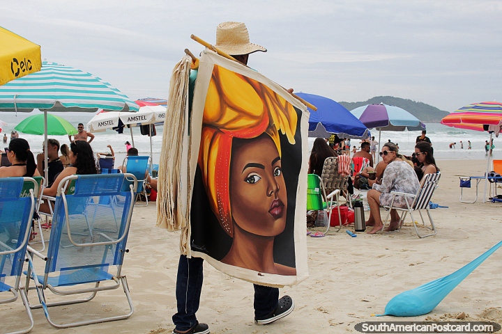 Un hombre vende tapices a lo largo de la playa de Santinho en Florianpolis. (720x480px). Brasil, Sudamerica.