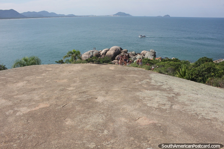 Huge rock face and view down to the coast and sea at Barra da Lagoa in Florianopolis. (720x480px). Brazil, South America.