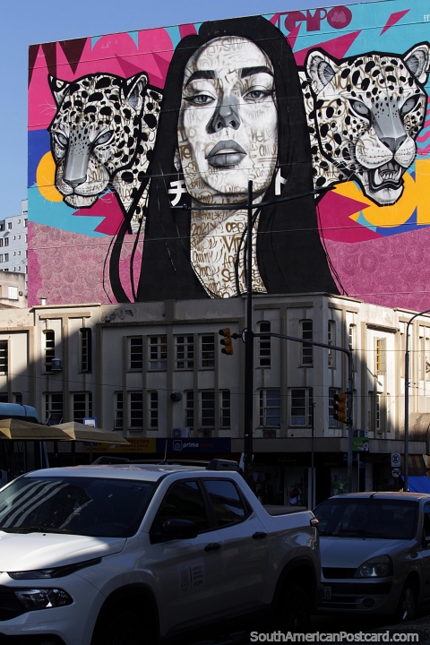 Woman flanked by a pair of leopards, large street mural in downtown Porto Alegre. (480x720px). Brazil, South America.