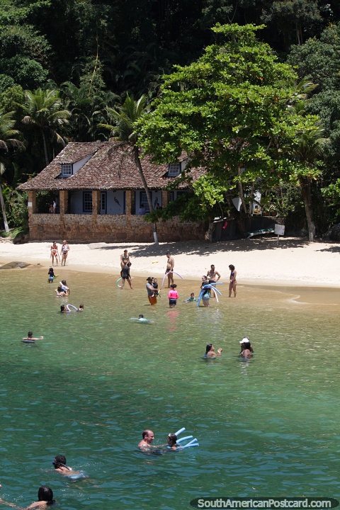 People enjoy the beaches of the islands in the bay in Paraty. (480x720px). Brazil, South America.