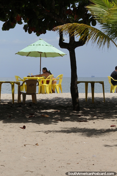 Enjoy a table at the beach under an umbrella in Mambucaba. (480x720px). Brazil, South America.