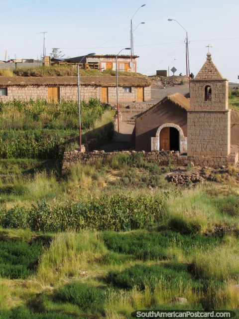 A small country church and grassy banks in a town in San Pedro de Atacama. (480x640px). Chile, South America.