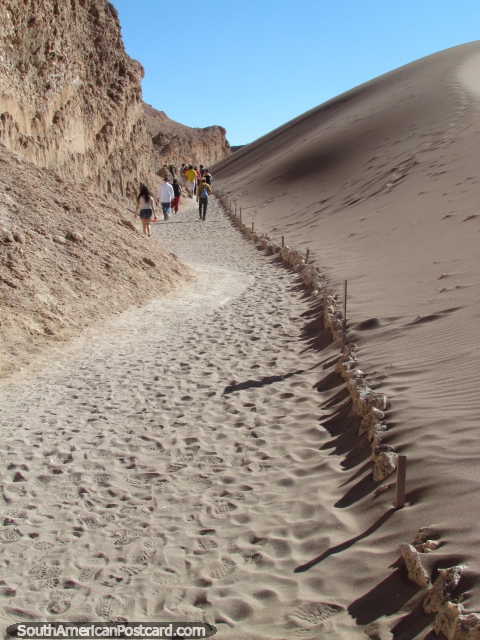 Making the ascent up the  path of sand to the Valley of the Moon at San Pedro de Atacama. (480x640px). Chile, South America.