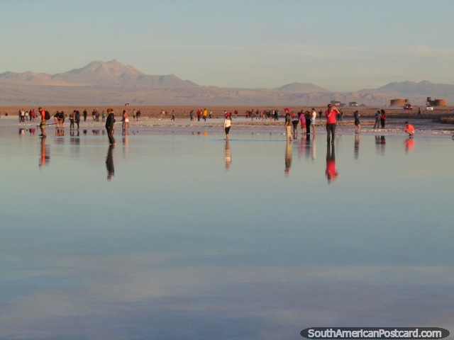 Many groups all together at days end enjoying the beginning of sunset at a reflecting lagoon, San Pedro de Atacama. (640x480px). Chile, South America.