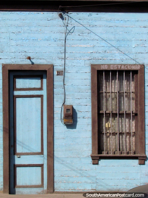 Wooden house, blue and grey, door and window, in Iquique. (480x640px). Chile, South America.