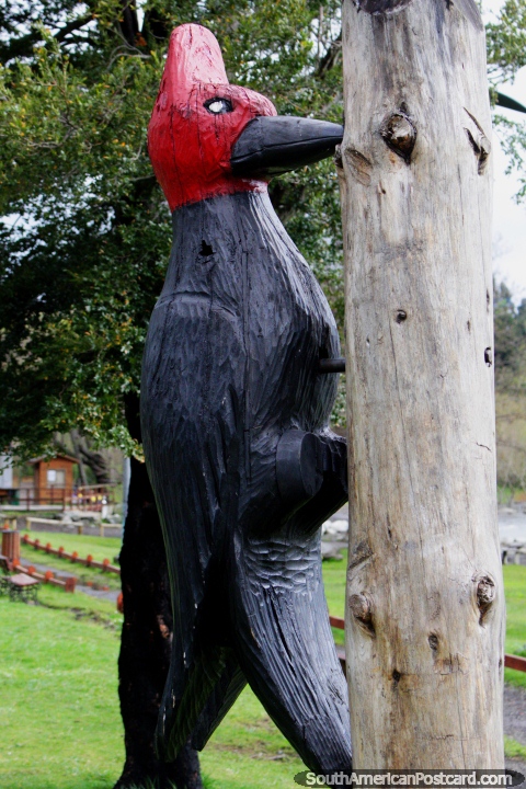 Woodpecker, wooden carving beside the lake in Pucon. (480x720px). Chile, South America.