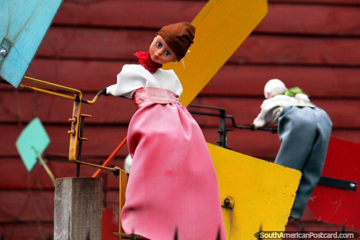 Dolls on a rooftop propelled by the wind to make the windmills go around in Pucon. (720x480px). Chile, South America.