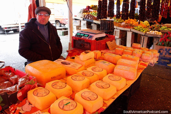 Man sells Mantecoso Cheese at the Feria Fluvial market in Valdivia. The rind is oily, the cheese inside is semi-firm with a rich butter-like taste. (720x480px). Chile, South America.