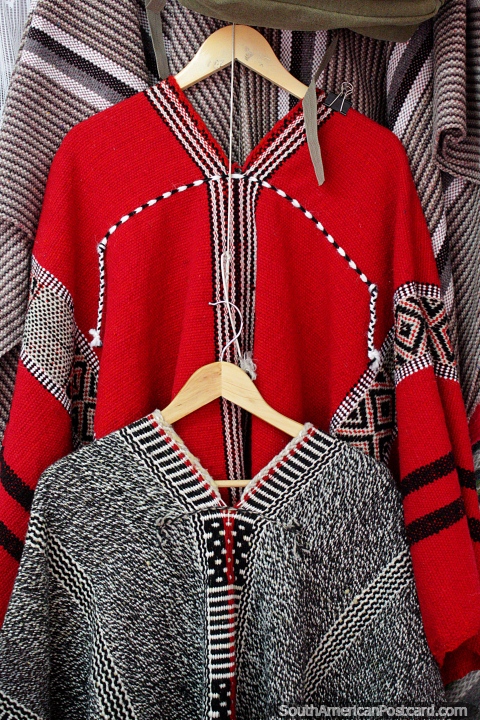 Red and grey woven jerseys for staying warm in winter, Valdivia market. (480x720px). Chile, South America.