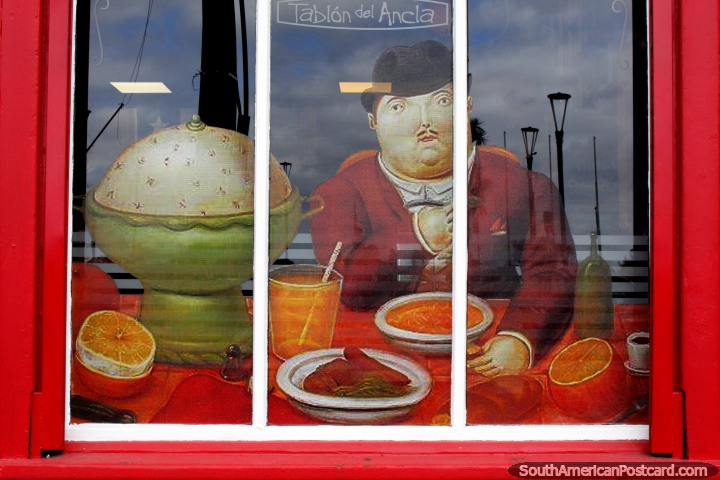 Man at a dinner table, paintings in the windows of the Tablon del Ancla Restaurant in Puerto Montt. (720x480px). Chile, South America.