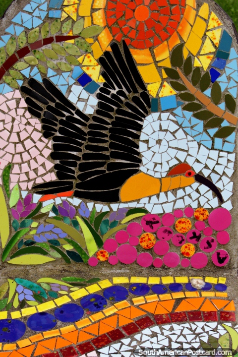 Bird flying in a colorful wilderness, tiled seats in the plaza in Puerto Montt. (480x720px). Chile, South America.
