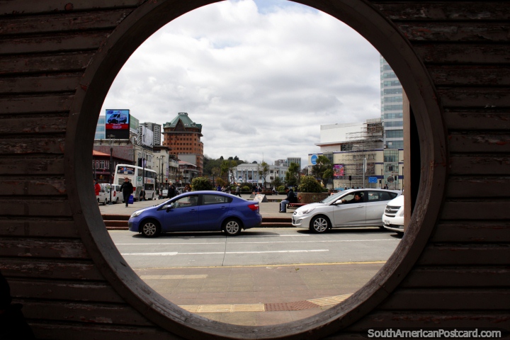 View of Puerto Montt through a round window, hotel, municipal and Ripley buildings. (720x480px). Chile, South America.