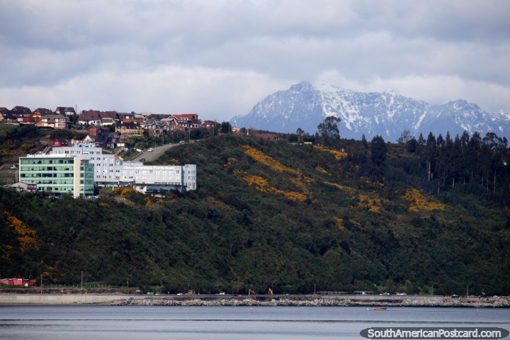 Snow-capped mountains and the Clinica Universitaria buildings in Puerto Montt. (720x480px). Chile, South America.