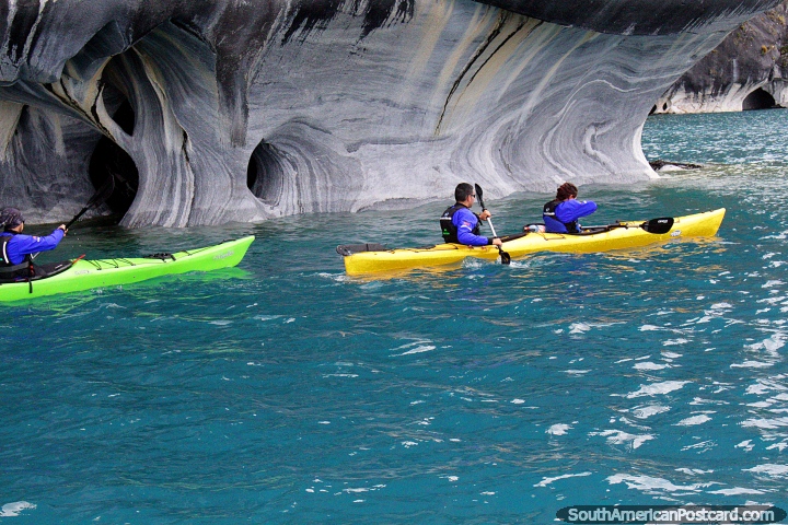 Kayaks explore around the marble caves on a cold October day in Puerto Rio Tranquilo. (720x480px). Chile, South America.