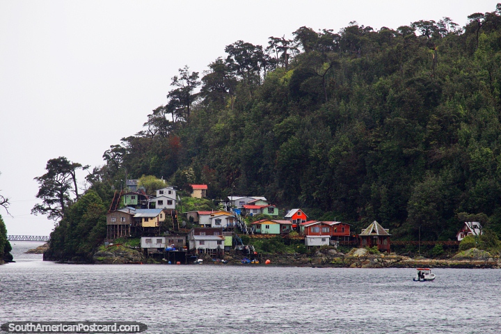 Wooden houses, some on stilts on the waters edge at Puerto Gala. (720x480px). Chile, South America.