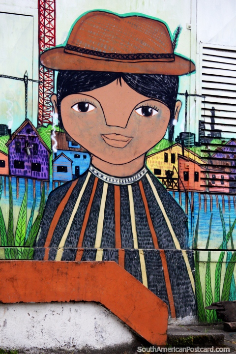 Woman with a brown hat, colorful houses behind her, street art in Castro. (480x720px). Chile, South America.