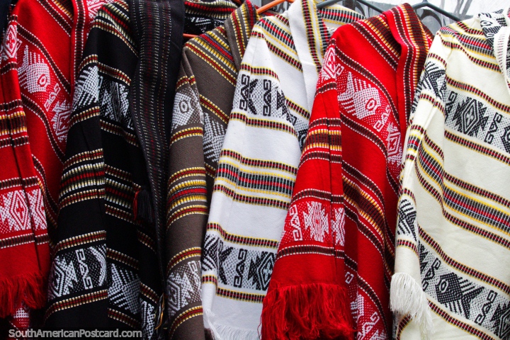 Red, brown and white ponchos with traditional designs, made in Castro. (720x480px). Chile, South America.