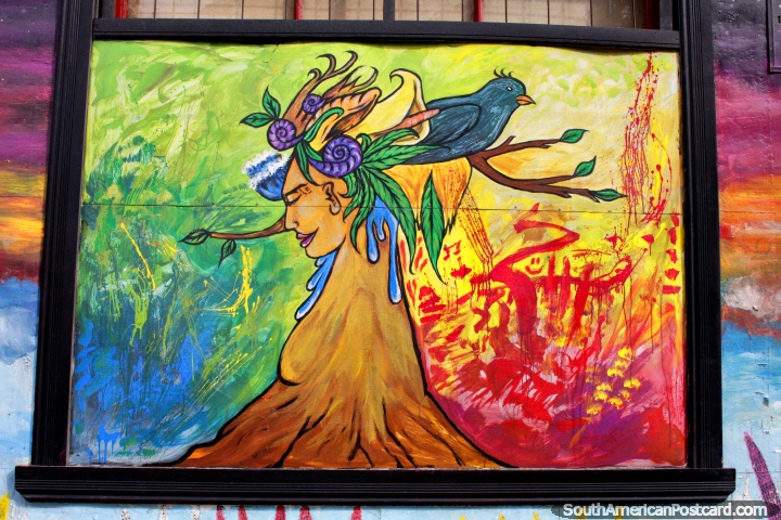 Face of a woman comes out from a volcano with a bird and flowers, abstract art in Punta Arenas. (720x480px). Chile, South America.
