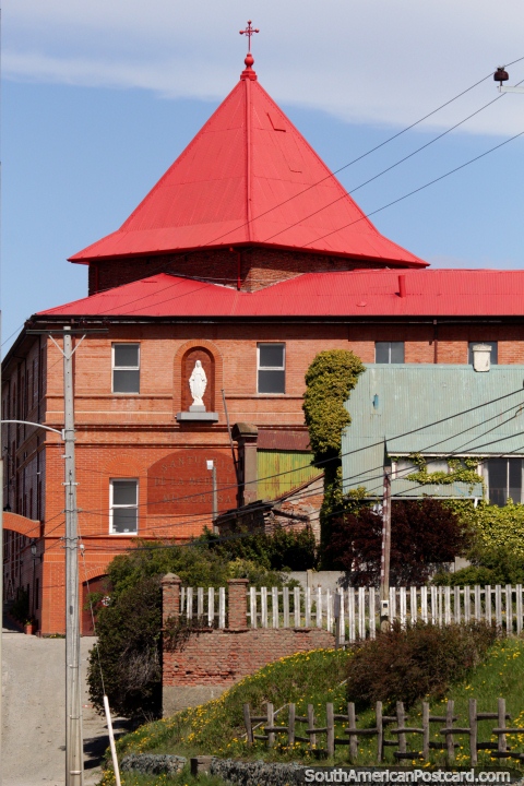 Red brick facade and steeple of the Sanctuary of Medalla Milagrosa in Punta Arenas. (480x720px). Chile, South America.