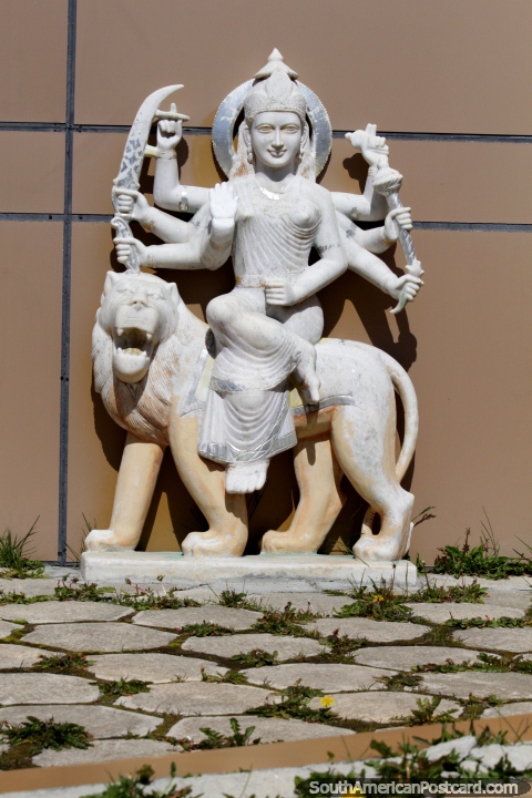 Female Hindu God with 8 arms rides a lion, marble sculpture at the temple in Punta Arenas. (480x720px). Chile, South America.