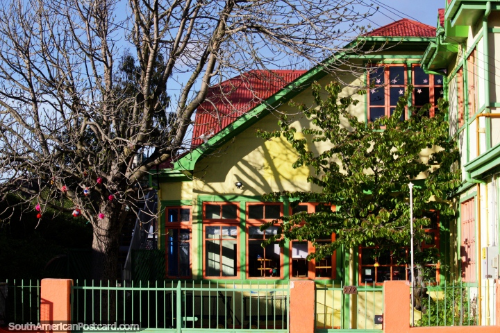 Beautiful green and yellow building sits well with the gardens and trees surrounding in Punta Arenas. (720x480px). Chile, South America.