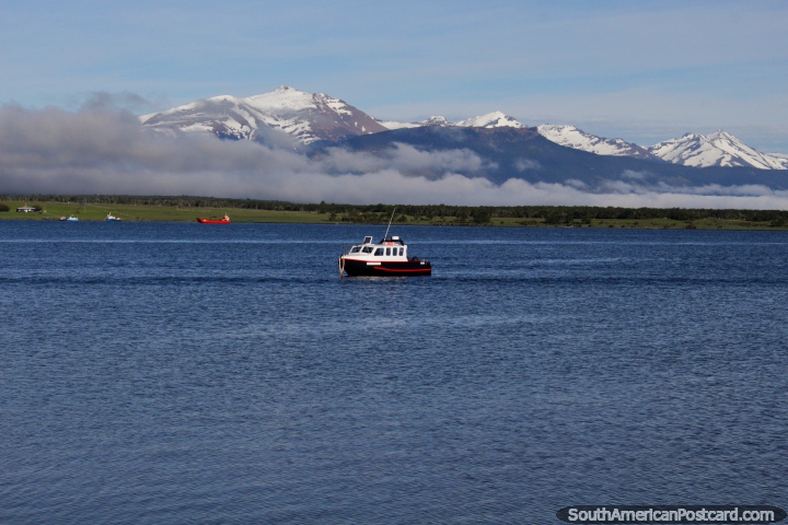 Clear day with the waters and mountains in the bay of Puerto Natales. (720x480px). Chile, South America.