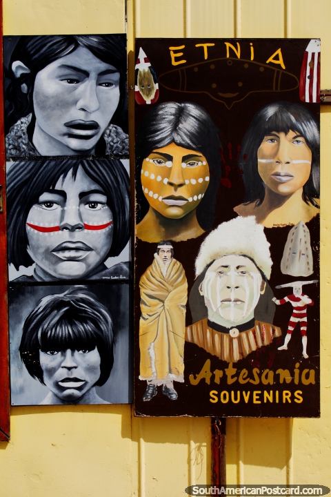As caras de pessoas étnicas pintaram de uma loja de ofïcios em Porto Natales. (480x720px). Chile, América do Sul.