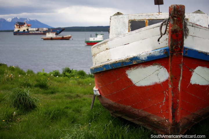 Boats around the port in Puerto Natales, one is on land. (720x480px). Chile, South America.