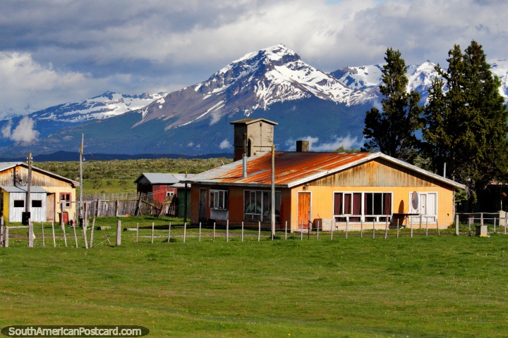 Huge wooden house in the countryside with green pastures and mountains, between Puerto Natales and Cerro Castillo. (720x480px). Chile, South America.