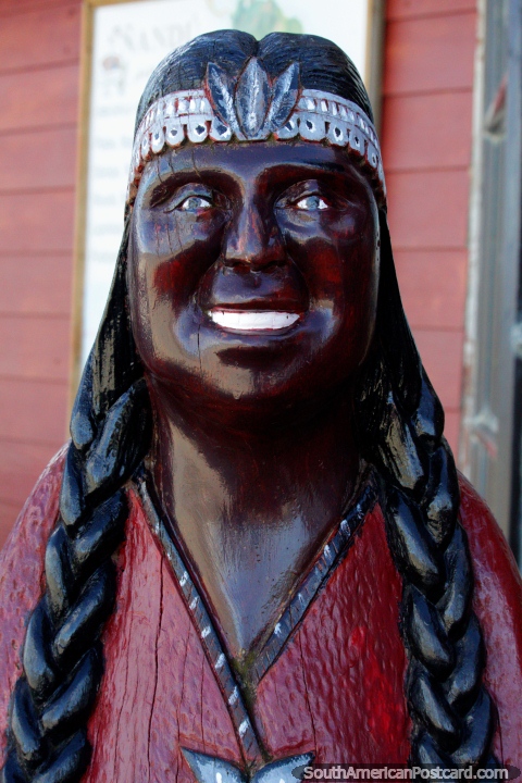 Wooden sculpture of an indigenous Indian at Villa Cerro Castillo. (480x720px). Chile, South America.