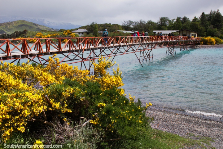 Crossing the bridge over Lake Pehoe to have lunch at Hosteria Pehoe at Torres del Paine. (720x480px). Chile, South America.