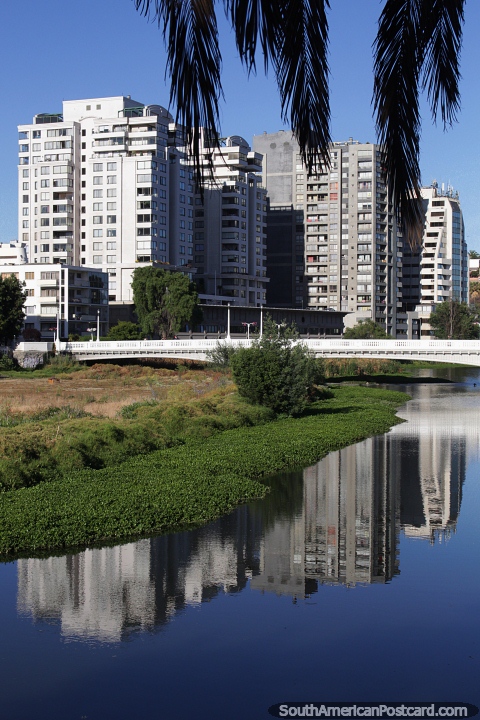 Modern buildings reflecting in the estuary in the morning in Vina del Mar. (480x720px). Chile, South America.