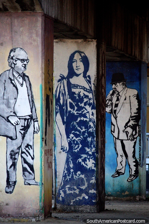 3 columns under a bridge  each with a figure painted upon it, street art in Valparaiso. (480x720px). Chile, South America.