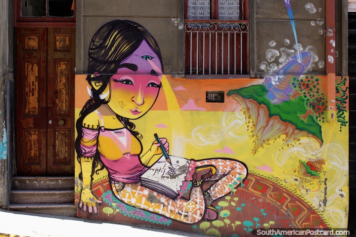 Girl with 3 eyes draws a picture and sits on a round rug, fantastic street art in Valparaiso. (720x480px). Chile, South America.