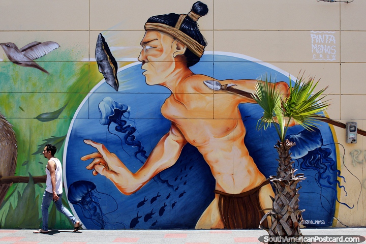 Warrior with a spear stalks the streets of Arica while trying to mingle with the public, magical street art. (720x480px). Chile, South America.