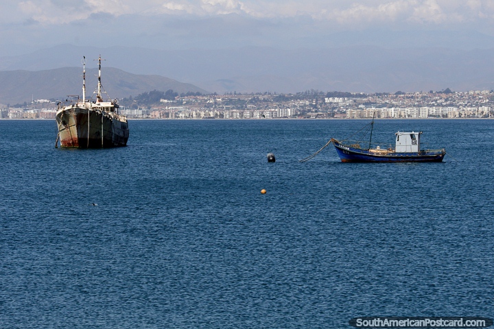 Blue waters in the bay in Coquimbo, boats and distant mountains. (720x480px). Chile, South America.