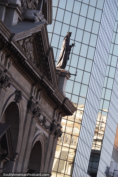 Estatua de la catedral y un edificio reflejado en el centro de Santiago. (480x720px). Chile, Sudamerica.