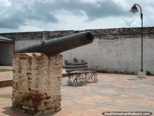A cannon, bench chair and lamp in Plaza del Dictador in Mompos. (640x480px). Colombia, South America.