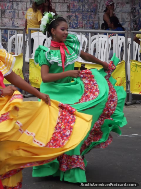 Woman dancers at Barranquilla Carnival in green and yellow dresses. (480x640px). Colombia, South America.