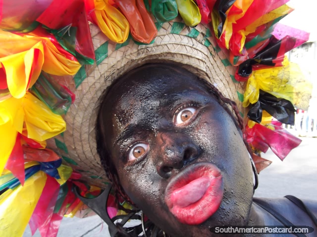 Big red lipped mumbo jumbo man poses with his colorful hat at Barranquilla Carnival. (640x480px). Colombia, South America.